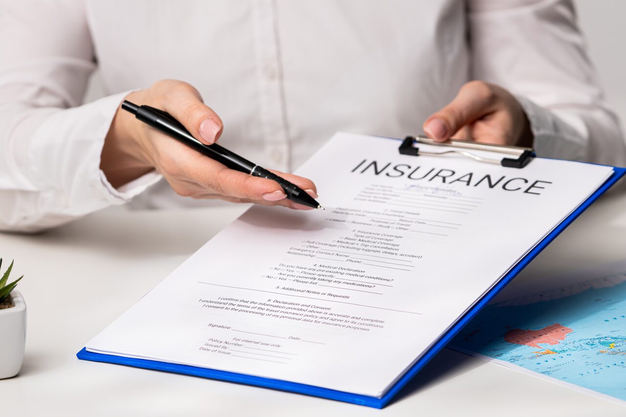 A team member presenting an insurance claim form on a clipboard