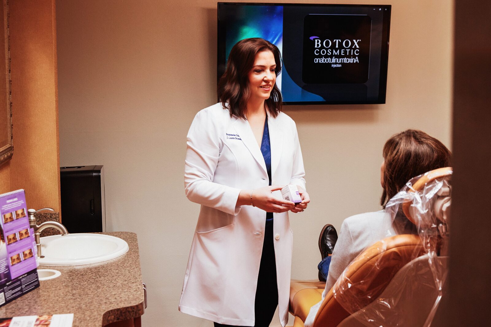 Dr. Brammeier discussing beauty injection treatment with a patient at our Lisle office