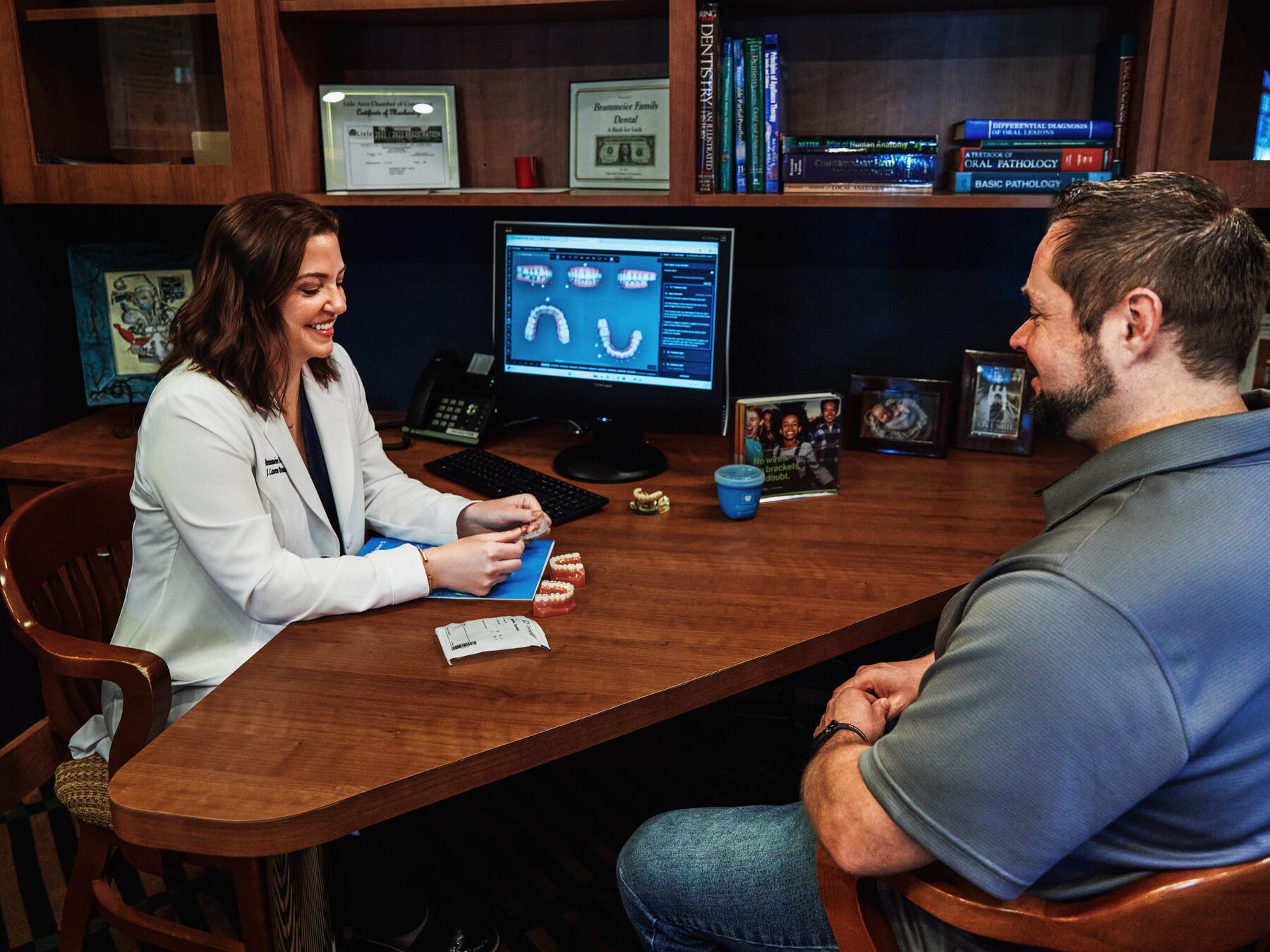 Dr. Brammeier reviewing a digital iTero scan with a patient at her desk