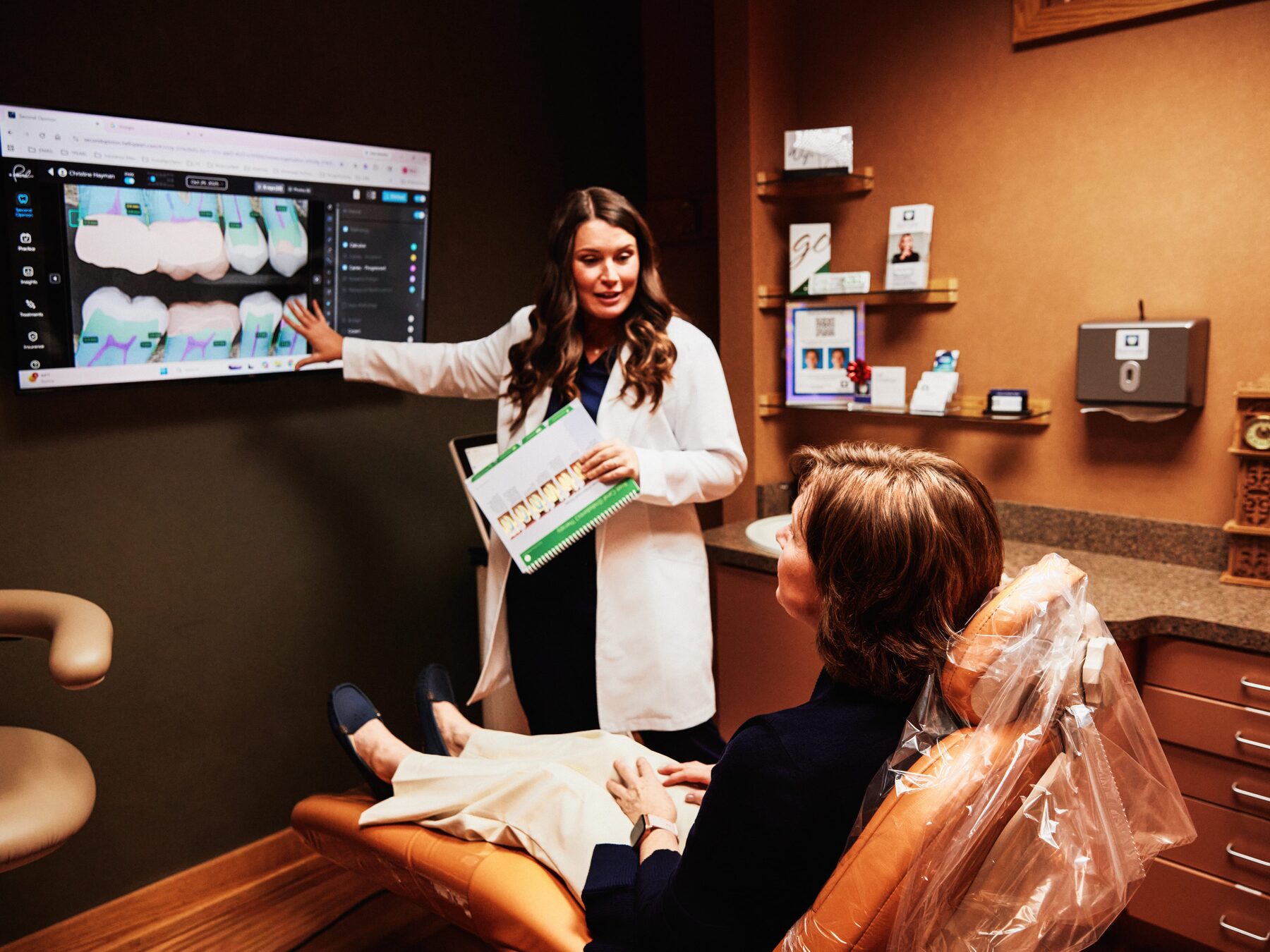 Dr. Brammeier explaining intraoral images on a large operatory screen