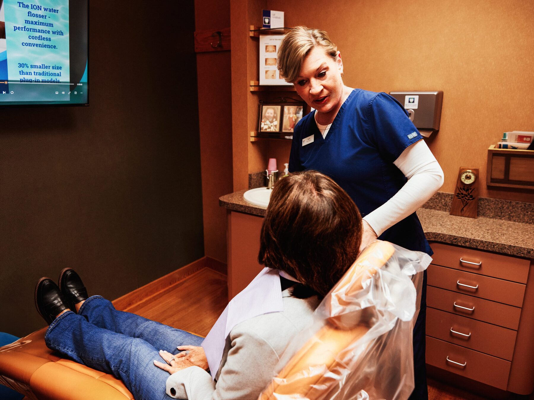Dental hygienist consulting with a patient at the start of a cleaning